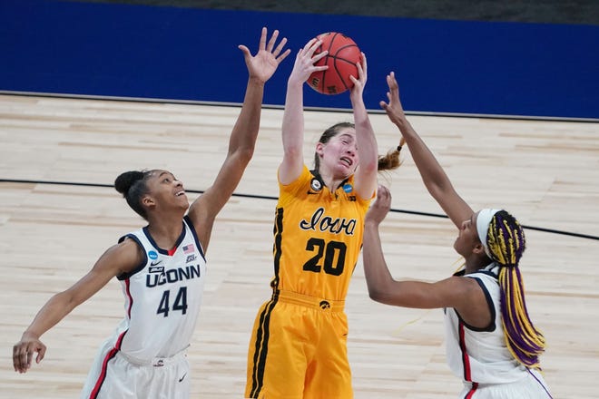 Iowa Hawkeyes guard Kate Martin (20) rebounds the ball between Connecticut Huskies forward Aubrey Griffin (44) and forward Aaliyah Edwards (3) in the Sweet 16 of the 2021 Women's NCAA Tournament, March 27, 2021, at Alamodome.