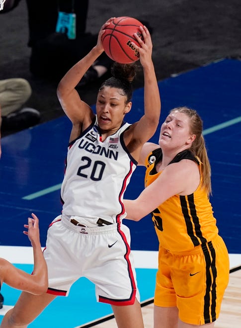 UConn forward Olivia Nelson-Ododa (20) pulls down a rebound over Iowa forward Monika Czinano, right, during the first half of a college basketball game in the Sweet 16 round of the women's NCAA tournament at the Alamodome in San Antonio, Saturday, March 27, 2021.