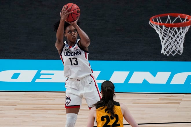 UConn guard Christyn Williams (13) shoots over Iowa guard Caitlin Clark (22) during the first half of a college basketball game in the Sweet 16 round of the women's NCAA tournament at the Alamodome in San Antonio, Saturday, March 27, 2021.