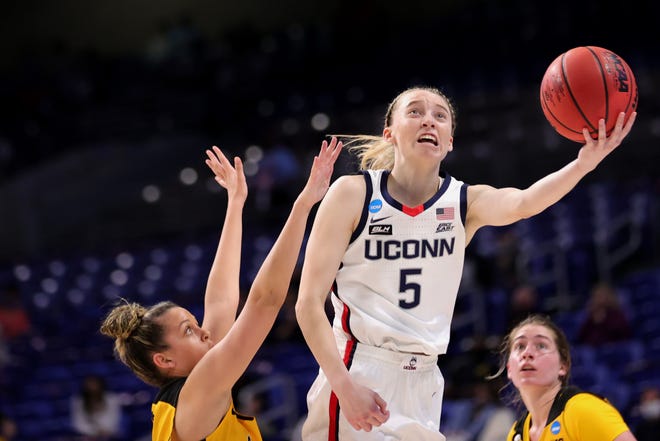 UConn's Paige Bueckers (5) puts up a shot over Iowa's Gabbie Marshall during the second half in the Sweet 16 round of the NCAA Women's Basketball Tournament at the Alamodome on March 27, 2021 in San Antonio, Texas.