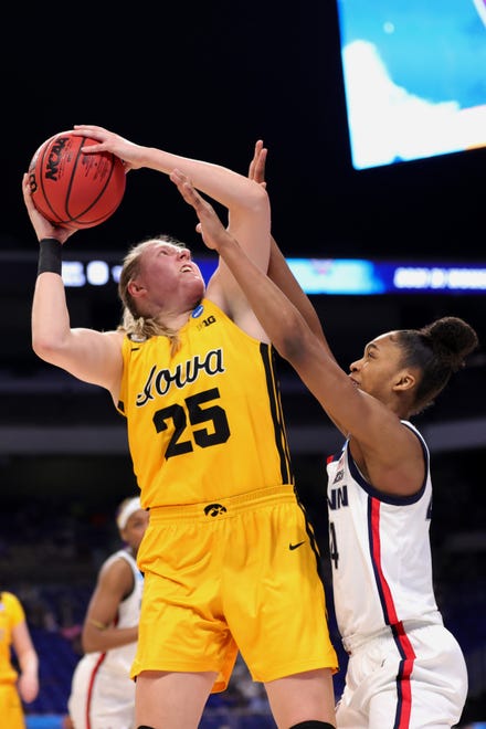 Iowa's Monika Czinano (25)  drives against UConn's Aubrey Griffin during the first half in the Sweet 16 round of the NCAA Women's Basketball Tournament at the Alamodome on March 27, 2021 in San Antonio, Texas.