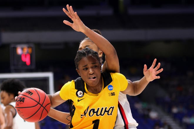 Iowa's Tomi Taiwo (1) of the Iowa Hawkeyes drives against UConn's Aubrey Griffin during the first half in the Sweet 16 round of the NCAA Women's Basketball Tournament at the Alamodome on March 27, 2021 in San Antonio, Texas.