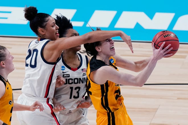Iowa guard Caitlin Clark, right, is fouled by UConn forward Olivia Nelson-Ododa (20) as she tires to score during the second half of a college basketball game in the Sweet Sixteen round of the women's NCAA tournament at the Alamodome in San Antonio, Saturday, March 27, 2021.
