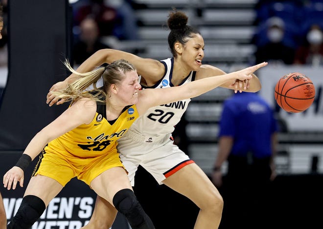 Iowa's Monika Czinano (25) and UConn's Olivia Nelson-Ododa (20) go after the ball in the first half during the Sweet 16 round of the NCAA Women's Basketball Tournament at the Alamodome on March 27, 2021 in San Antonio, Texas.