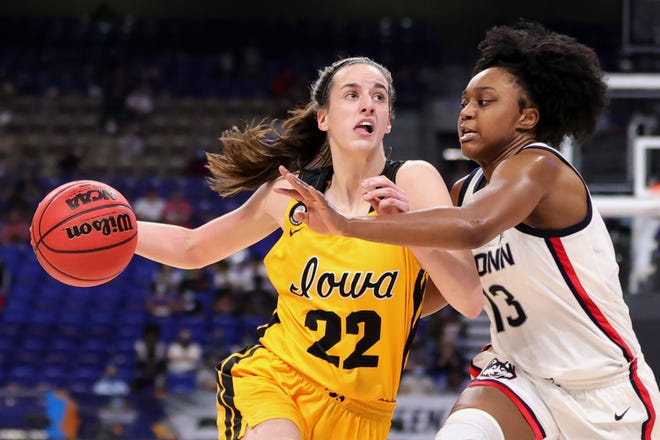 Iowa's Caitlin Clark (22) drives against UConn's Christyn Williams (13)  during the first half in the Sweet 16 round of the NCAA Women's Basketball Tournament at the Alamodome on March 27, 2021 in San Antonio, Texas.
