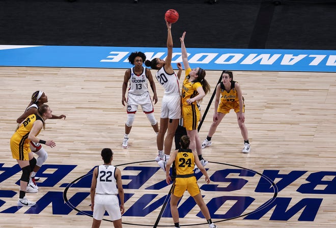UConn Huskies forward Olivia Nelson-Ododa (20) and Iowa Hawkeyes guard McKenna Warnock (14) battle for the opening tipoff during the first quarter in the Sweet 16 of the 2021 Women's NCAA Tournament, March 27, 2021, at Alamodome.