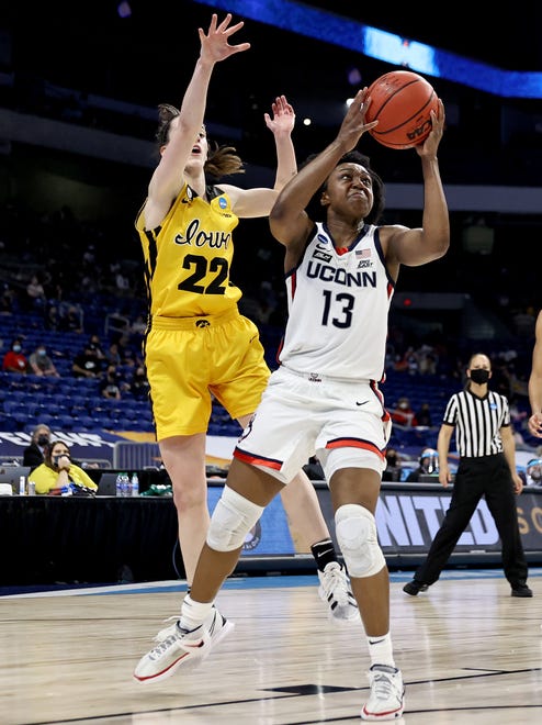 UConn's Christyn Williams (13) drives to the basket as Iowa's Caitlin Clark (22) defends in the first half during the Sweet 16 round of the NCAA Women's Basketball Tournament at the Alamodome on March 27, 2021 in San Antonio, Texas.