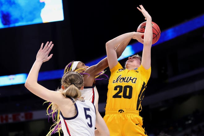 UConn's Aaliyah Edwards blocks a shot attempt by Iowa's Kate Martin (20) during the first half in the Sweet 16 round of the NCAA Women's Basketball Tournament at the Alamodome on March 27, 2021 in San Antonio, Texas.
