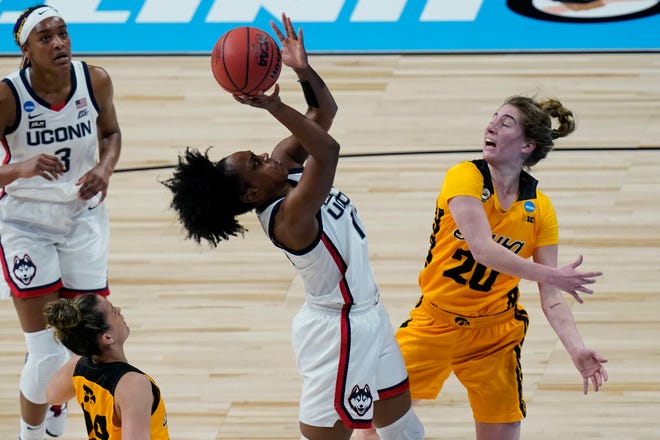 UConn guard Christyn Williams shoots over Iowa guard Kate Martin (20) during the first half of a college basketball game in the Sweet 16 round of the women's NCAA tournament at the Alamodome in San Antonio, Saturday, March 27, 2021.