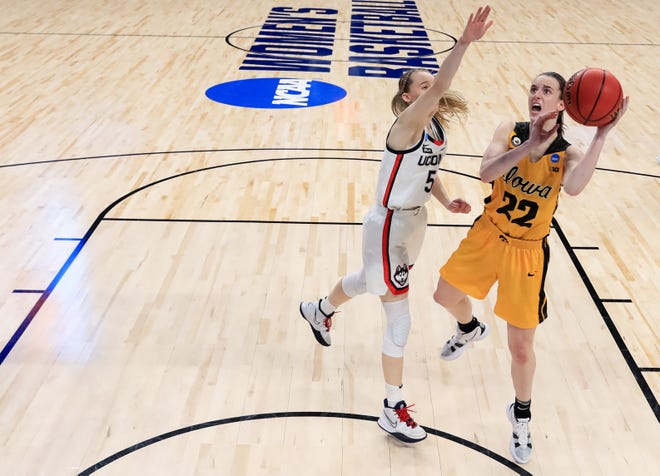 Iowa guard Caitlin Clark (22) drives to the basket against UConn's Paige Bueckers (5) during the second half in the Sweet 16 round of the NCAA Women's Basketball Tournament at the Alamodome on March 27, 2021 in San Antonio, Texas.