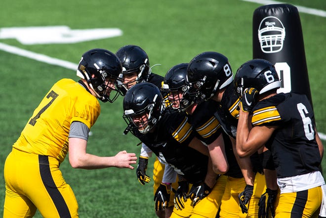 Iowa quarterback Spencer Petras (7) huddles up with teammates during a NCAA Big Ten Conference football spring practice, Saturday, April 17, 2021, at Kinnick Stadium in Iowa City, Iowa.