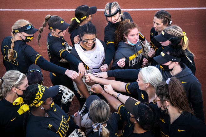 Iowa Hawkeyes players huddle up before a NCAA Big Ten Conference softball game against Northwestern, Saturday, April 17, 2021, at Bob Pearl Field in Iowa City, Iowa.