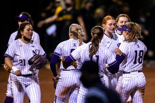 Northwestern players celebrate after a NCAA Big Ten Conference softball game against Iowa, Saturday, April 17, 2021, at Bob Pearl Field in Iowa City, Iowa.