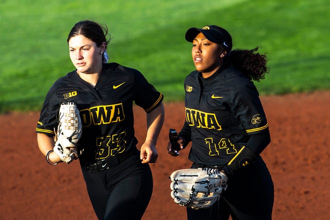 Iowa's Riley Sheehy, left, and Nia Carter run to the dugout during a NCAA Big Ten Conference softball game against Northwestern, Saturday, April 17, 2021, at Bob Pearl Field in Iowa City, Iowa.