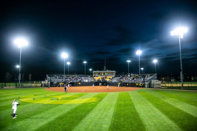 Northwestern players settle in on defense as the sun sets during a NCAA Big Ten Conference softball game against Iowa, Saturday, April 17, 2021, at Bob Pearl Field in Iowa City, Iowa.