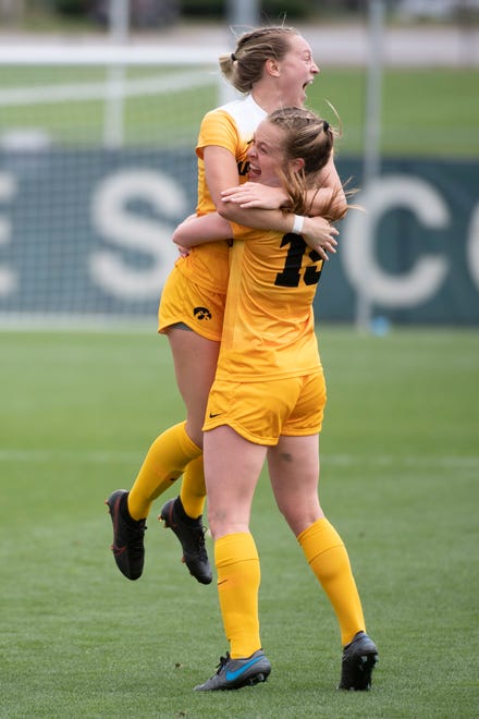 Iowa forward Jenny Cape (19) is embraced by teammate Hailey Rydberg after scoring the opening goal during an NCAA college soccer game in the final of the Big Ten Conference tournament, Sunday, April 17, 2021, in State College, Pennsylvania.