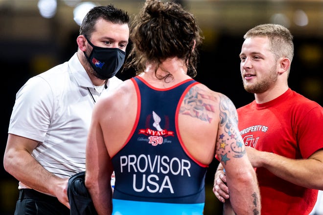 Ben Provisor talks with coaches between periods while wrestling at 82 kg during the UWW Senior national Greco-Roman wrestling championships, Friday, April 30, 2021, at the Xtream Arena in Coralville, Iowa.