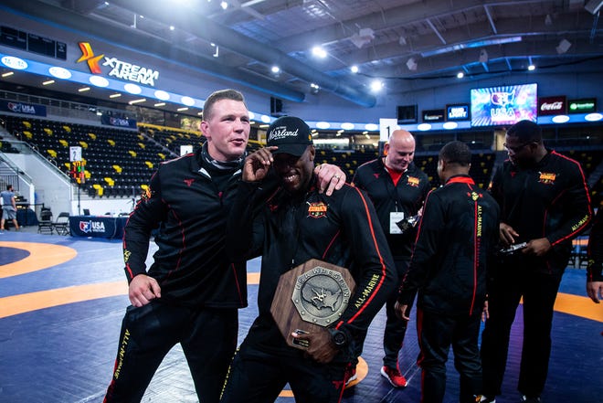 Members of the All-Marine Wrestling Team celebrate after the UWW Senior national Greco-Roman wrestling championships, Friday, April 30, 2021, at the Xtream Arena in Coralville, Iowa.