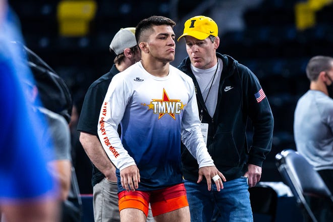 Hawkeye Wrestling Club advisor Tom Brands, right, talks with Pat Lugo as he warms up before wrestling at 65 kg during the UWW Senior National freestyle championships, Saturday, May 1, 2021, at the Xtream Arena in Coralville, Iowa.