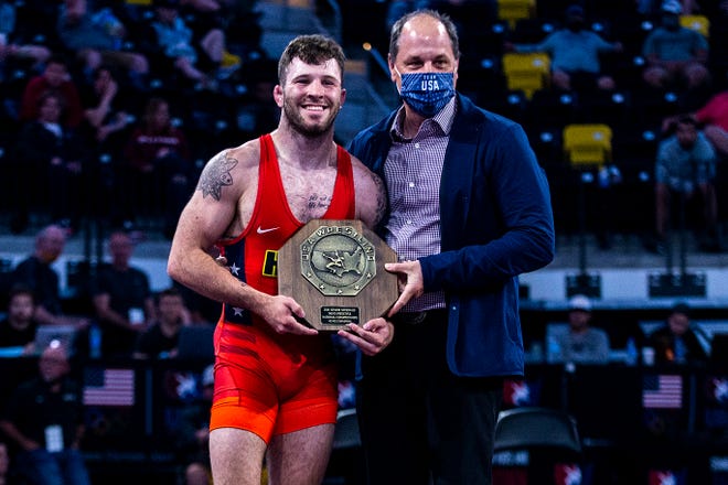 Jaydin Eierman is presented with his stop sign trophy after winning at 65 kg during the UWW Senior National freestyle wrestling championships, Saturday, May 1, 2021, at the Xtream Arena in Coralville, Iowa.