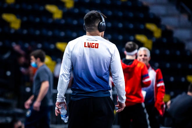 Pat Lugo walks out to the mat before wrestling at 65 kg during the UWW Senior National freestyle championships, Saturday, May 1, 2021, at the Xtream Arena in Coralville, Iowa.