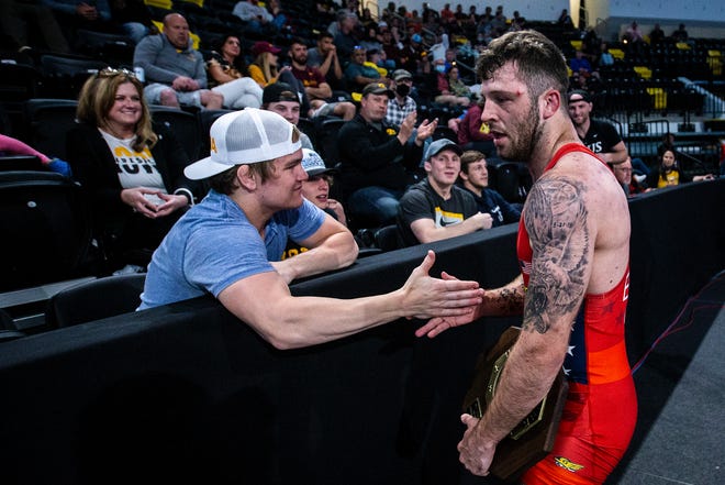 Jaydin Eierman, right, high-fives Nelson Brands after winning his match in the finals at 65 kg during the UWW Senior National freestyle wrestling championships, Saturday, May 1, 2021, at the Xtream Arena in Coralville, Iowa.
