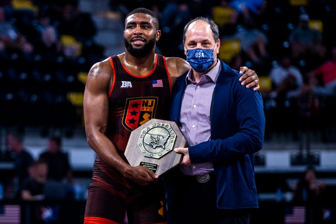 Nate Jackson is presented with his stop sign trophy after winning in the finals at 92 kg during the UWW Senior National freestyle wrestling championships, Saturday, May 1, 2021, at the Xtream Arena in Coralville, Iowa.