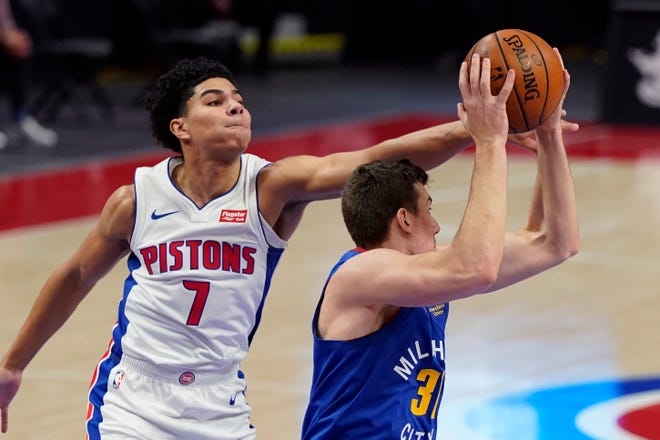 Pistons guard Killian Hayes reaches in on Nuggets forward Vlatko Cancar during the first half on Friday, May 14, 2021, at Little Caesars Arena.