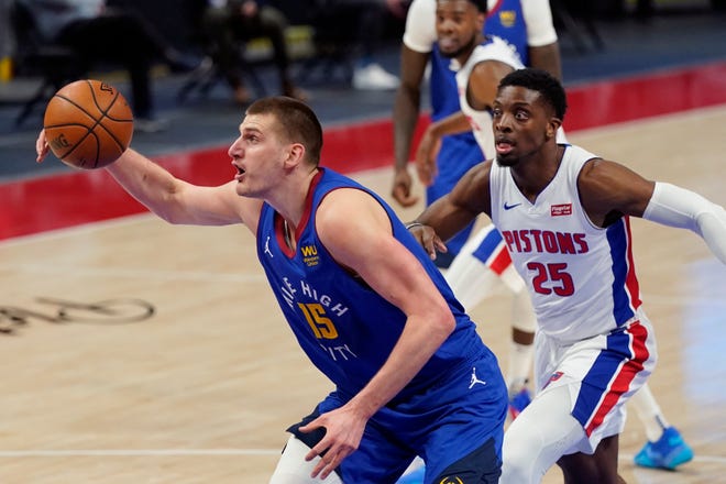 Nuggets center Nikola Jokic grabs a rebound in front of Pistons forward Tyler Cook during the first half on Friday, May 14, 2021, at Little Caesars Arena.