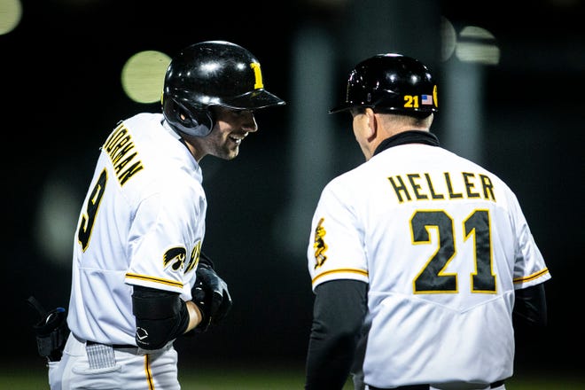 Iowa's Ben Norman (9) celebrates with Iowa head coach Rick Heller after hitting a triple during a NCAA Big Ten Conference baseball game against Illinois, Friday, May 14, 2021, at Duane Banks Field in Iowa City, Iowa.