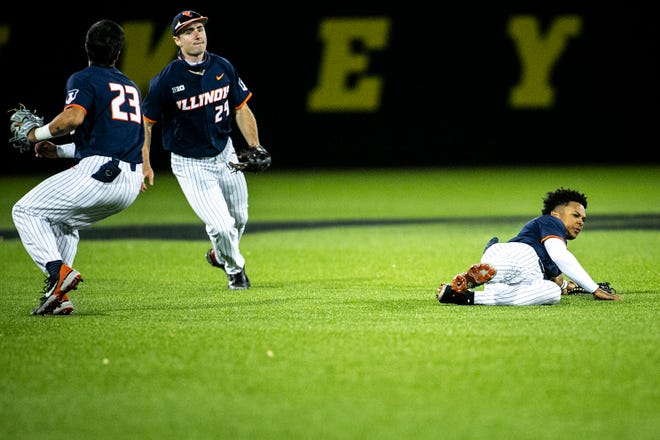 Illinois' Branden Comia (23) Nathan Aide (29) and Taylor Jackson, right, can't come up with an out during a NCAA Big Ten Conference baseball game against Iowa, Friday, May 14, 2021, at Duane Banks Field in Iowa City, Iowa.