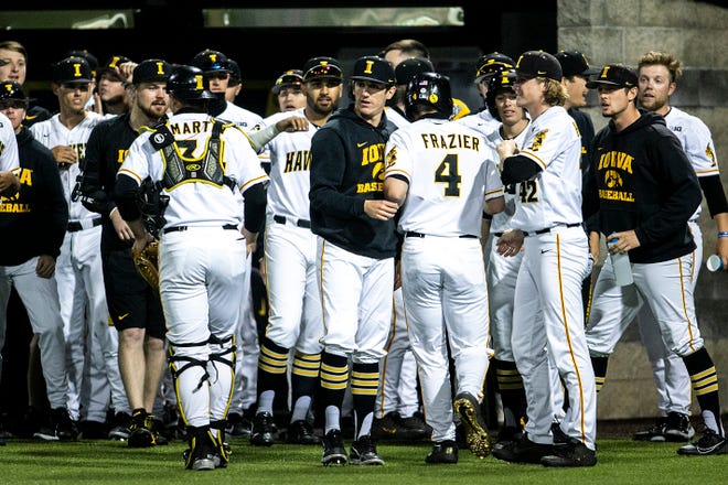 Iowa's Brayden Frazier (4) celebrates with teammates after scoring a run during a NCAA Big Ten Conference baseball game against Illinois, Friday, May 14, 2021, at Duane Banks Field in Iowa City, Iowa.