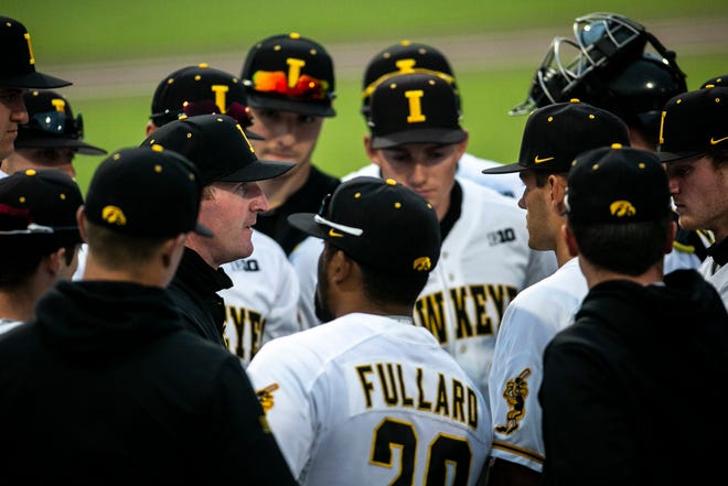 Iowa associate head coach Marty Sutherland talks with players between innings during a NCAA Big Ten Conference baseball game against Illinois, Friday, May 14, 2021, at Duane Banks Field in Iowa City, Iowa.