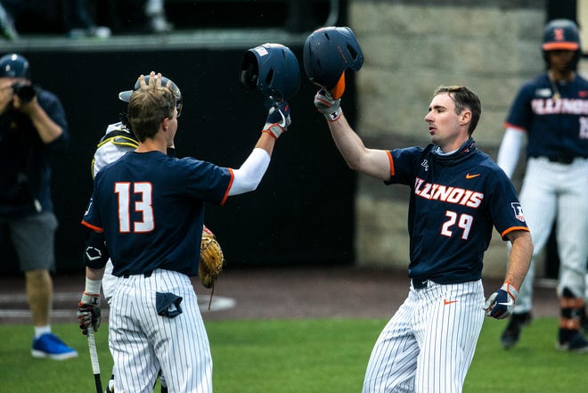 Illinois' Nathan Aide (29) celebrates a run with teammate Cal Hejza (13) during a NCAA Big Ten Conference baseball game against Iowa, Friday, May 14, 2021, at Duane Banks Field in Iowa City, Iowa.