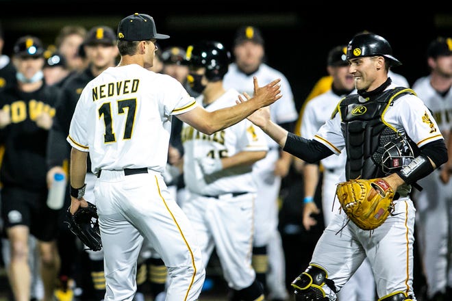Iowa's Dylan Nedved (17) celebrates with catcher Austin Martin (34) after a NCAA Big Ten Conference baseball game against Illinois, Friday, May 14, 2021, at Duane Banks Field in Iowa City, Iowa.