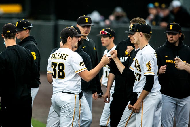 Iowa pitcher Trenton Wallace (38) is greeted by teammates after closing out an inning during a NCAA Big Ten Conference baseball game against Illinois, Friday, May 14, 2021, at Duane Banks Field in Iowa City, Iowa.