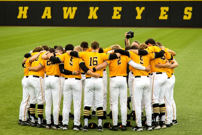 Iowa Hawkeyes players huddle up before a NCAA Big Ten Conference baseball game against Illinois, Sunday, May 16, 2021, at Duane Banks Field in Iowa City, Iowa.