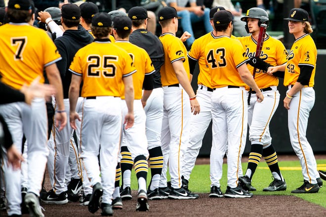 Iowa's Trenton Wallace (38) celebrates with teammates after scoring a run during a NCAA Big Ten Conference baseball game against Illinois, Sunday, May 16, 2021, at Duane Banks Field in Iowa City, Iowa.