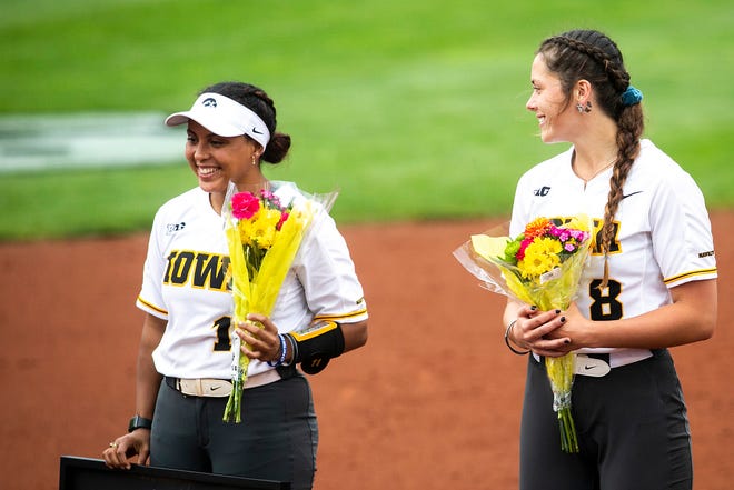 Iowa seniors Avery Guy, left, and Lauren Shaw (8) smile as teammates are acknowledged after a NCAA Big Ten Conference softball game against Illinois, Sunday, May 16, 2021, at Bob Pearl Field in Iowa City, Iowa.