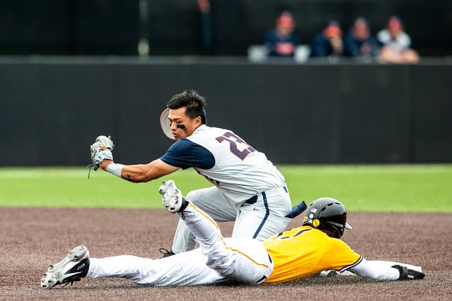 Iowa's Dylan Nedved (17) slides into second base ahead of the tag from Illinois' Branden Comia (23) during a NCAA Big Ten Conference baseball game, Sunday, May 16, 2021, at Duane Banks Field in Iowa City, Iowa.