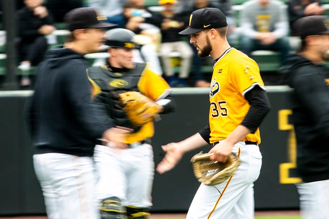 Iowa pitcher Cam Baumnn (35) gets a high-five while heading into the dugout during a NCAA Big Ten Conference baseball game against Illinois, Sunday, May 16, 2021, at Duane Banks Field in Iowa City, Iowa.