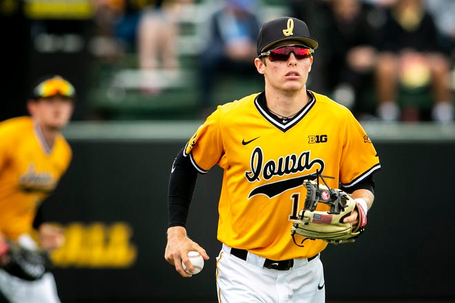 Iowa's Michael Seegers (13) helps teammates warm up during a NCAA Big Ten Conference baseball game against Illinois, Sunday, May 16, 2021, at Duane Banks Field in Iowa City, Iowa.