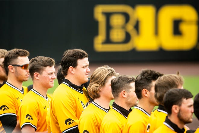 Iowa's Peyton Williams, third from left, stands with teammates as the national anthem is played before a NCAA Big Ten Conference baseball game against Illinois, Sunday, May 16, 2021, at Duane Banks Field in Iowa City, Iowa.