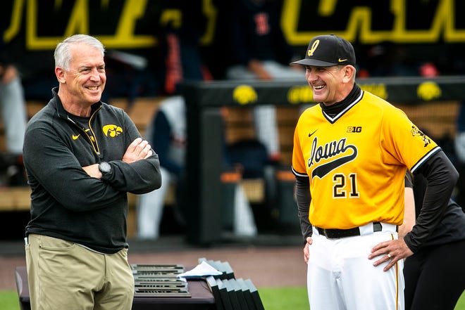 Iowa athletic director Gary Barta, left, and Iowa head coach Rick Heller share a laugh before a NCAA Big Ten Conference baseball game against Illinois, Sunday, May 16, 2021, at Duane Banks Field in Iowa City, Iowa.