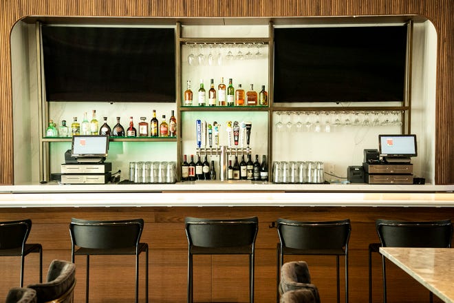 Glasses and bottles are displayed behind the bar on the first floor, Wednesday, May 26, 2021, at the Courtyard Marriott in University Heights, Iowa.