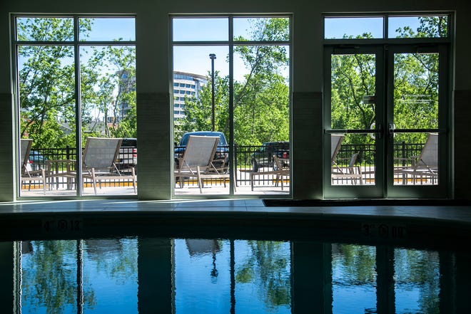 Reflections from windows are seen in the pool, Wednesday, May 26, 2021, at the Courtyard Marriott in University Heights, Iowa.