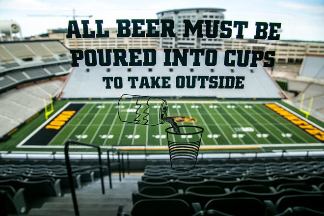 A window sticker reads "All beer must be poured into cups to take outside," Tuesday, June 22, 2021, on the second level outdoor club at Kinnick Stadium in Iowa City, Iowa.