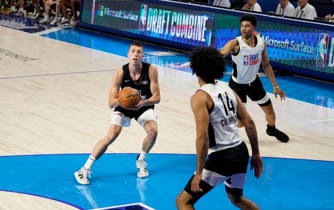 Iowa's Joe Wieskamp, left, rises to shoot the ball during the NBA Draft Combine, Thursday, June 24, 2021, at the Wintrust Arena in Chicago.