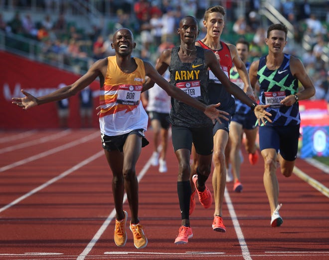 Hillary Bor, left, celebrates his victory in the men's steeplechase with silver medal winner Benard Keter, center and Mason Ferlic, right, at the U.S. Olympic Track and Field Trials at Hayward Field.