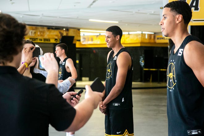 Iowa forward Kris Murray, center, talks with reporters as his twin brother Iowa forward Keegan Murray, right, does the same during a summer Hawkeyes men's basketball media availability, Tuesday, June 29, 2021, at Carver-Hawkeye Arena in Iowa City, Iowa.